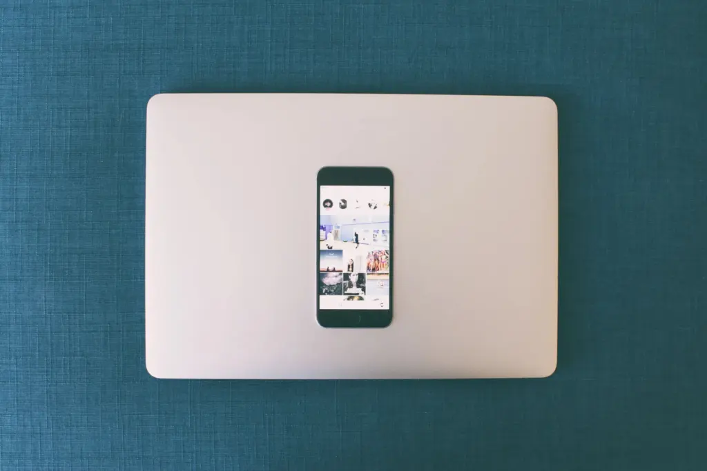 Person browsing social media on a laptop and phone