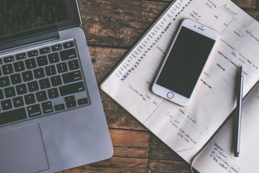 Smartphone and laptop on a desk showing a technology blog