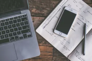 Smartphone and laptop on a desk showing a technology blog