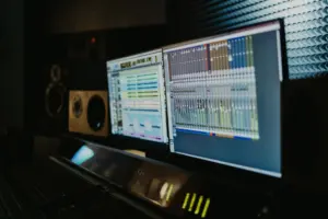 Speaker and laptop on a desk for audio reviews
